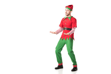 cheerful man in christmas elf costume outstreching hands in excitement isolated on white