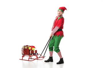 man in christmas elf costume crrying pile of presents isolated on white
