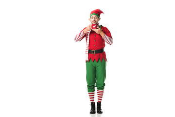 man in christmas elf costume with eyes closed holding cup of tea and inhaling aroma isolated on white