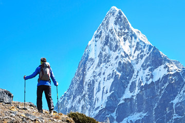 Fototapeta premium Hiker with backpacks reaches the summit of mountain peak. Success, freedom and happiness, achievement in mountains. Active sport concept.