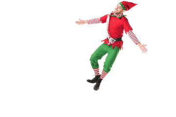 Fototapeta na wymiar happy man in christmas elf costume jumping isolated on white background