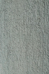 The rough wall covered with plaster of light green mint color
