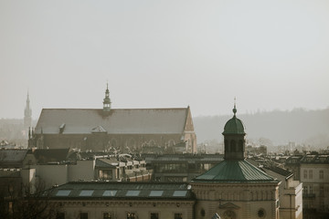 Roofs panorama with towers of the Poland city Kraków during the winter day with grey overcast sky