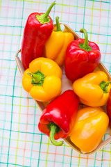 yellow and red peppers closeup on colorful napkin.