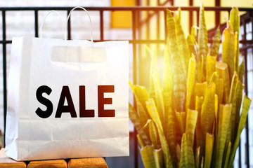  sale bag on wood table in garden