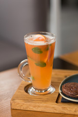 Orange citrus beverage with mint leaves
