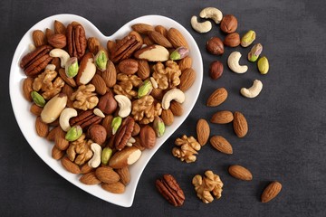 Nuts on a plate in the shape of a heart.
