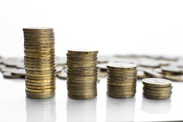on a white background with a reflection of a lot of scattered coins and a column