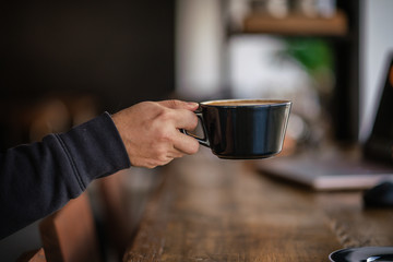 Hand Reaching For Coffee Latte