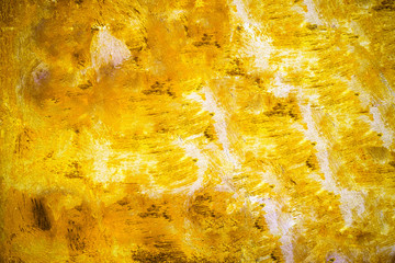 Yellow metal plate painted with strong yellow, orange and white vivid colours as colourful metallic surface texture abstract background.