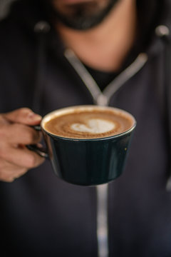 Man Holding Cup of Coffee Latte