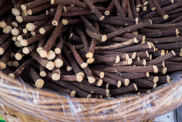 Liquorice roots on  wicker basket, exposed for sale at a fair