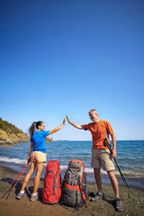 Fototapeta premium Adventure trek along the coast with a backpack in the summer.