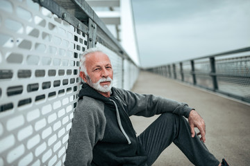 Portrait of senior athlete in the city environment, looking at camera.