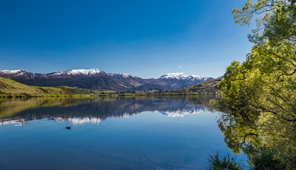 Fototapeta na wymiar Lake Hayes reflecting Coronet mountains, near Queenstown, New Zealand