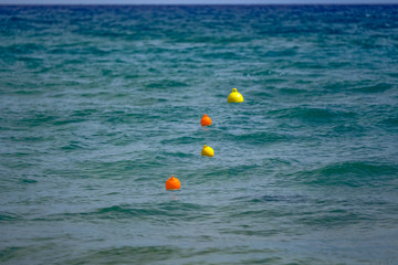 Multicolored buoys in the sea in Greece