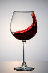 beautiful splash of red wine in a glass