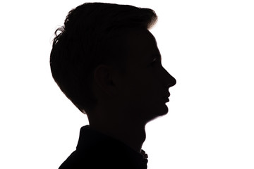 silhouette of an unrecognizable guy, man face profile on a white isolated background