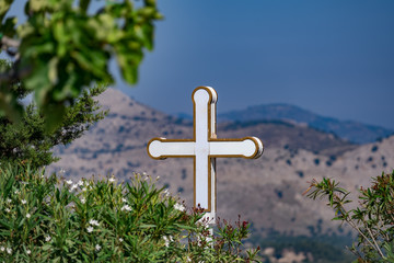 Orthodox cross on the background of the mountains in Greece