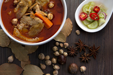 Chicken massaman curry with herb on wooden background, coconut milk curry, Thai local food