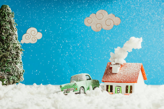 Close-up Shot Of Toy Car And House Covered With Snow, Christmas Concept