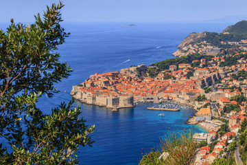 Dubrovnik old town surrounded by fortified walls above the Adriatic sea, Croatia. Picturesque view on the old town (medieval Ragusa) and Dalmatian Coast of Adriatic Sea.