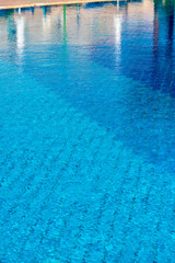 Fototapeta na wymiar Background with a Blue Water in a Swimming Pool