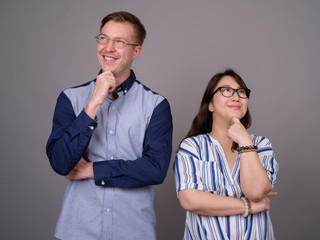 Portrait of happy multi ethnic diverse couple thinking