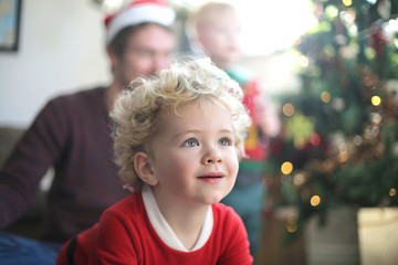 Beautiful baby waiting for his christmas gift