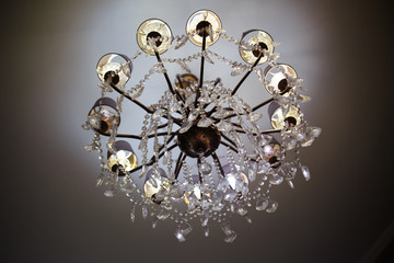 Stylish crystal chandelier on the ceiling.