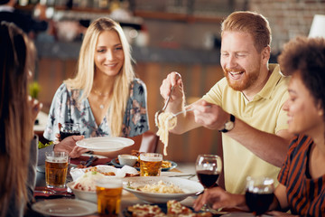 Friends having dinner at restaurant. Multi ethnic group.