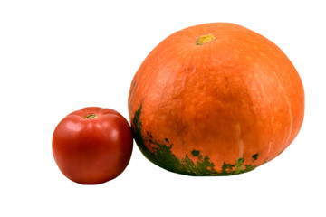 Small orange pumpkin and tomato isolated on white background