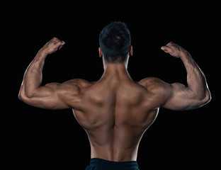 Fototapeta na wymiar Brutal strong bodybuilder athletic man posing on black background.