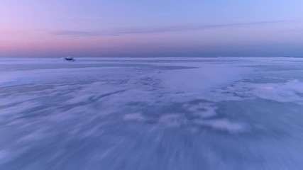 Fast and low flying over ice field in winter. Frozen sea ice winter landscape. - Powered by Adobe