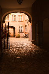 Arched entrance to courtyard on old European building
