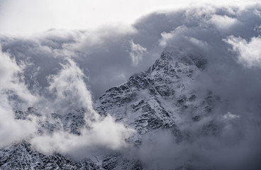 Mountain peeks surrounded in clouds. Concept - mountaineering, mountains, the pursuit of the peaks, the top