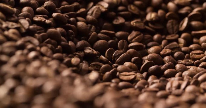 Coffee beans roasted rotating blurred background medium shot abstract video.
