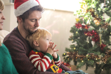 Sweet parents spending christmas time with their son