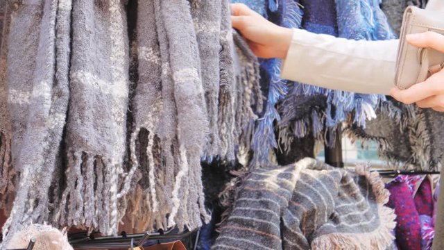 Woman choising Cashmere shawles and scarves