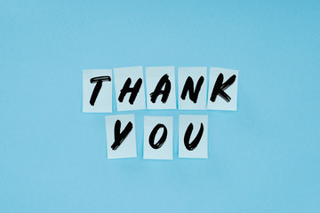 thank you wording on sticky notes isolated on blue background