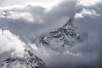 Mountain peeks surrounded in clouds.