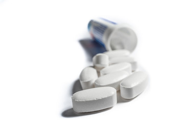 Antibiotic pills with packaging on a white background