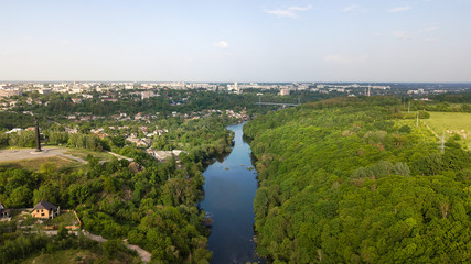 Aerial view of a river with trees and houses on the shore