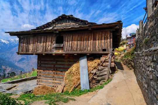 Traditional wooden house overhanging valley in Himalayas, India
