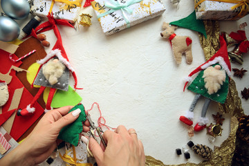 woman sews New Year's felt toys.Top view