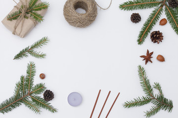 Christmas composition. Christmas gift, aroma sticks, pine cones, fir branches on white background....