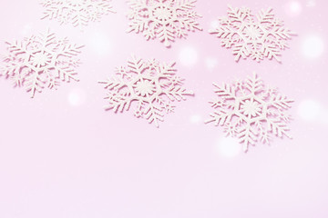 Snowflakes on Lighy Pink Background Holiday Festive Christmas Winter Concept Copy Space Top View Minimal Toned