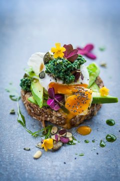 Bread topped with an avocado, egg and kale tapenade
