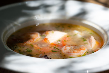 seafood, traditional russian fish soup, close up blurred view