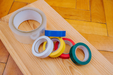 Color rolls of gaffer tape, duct tape, on a wood background
